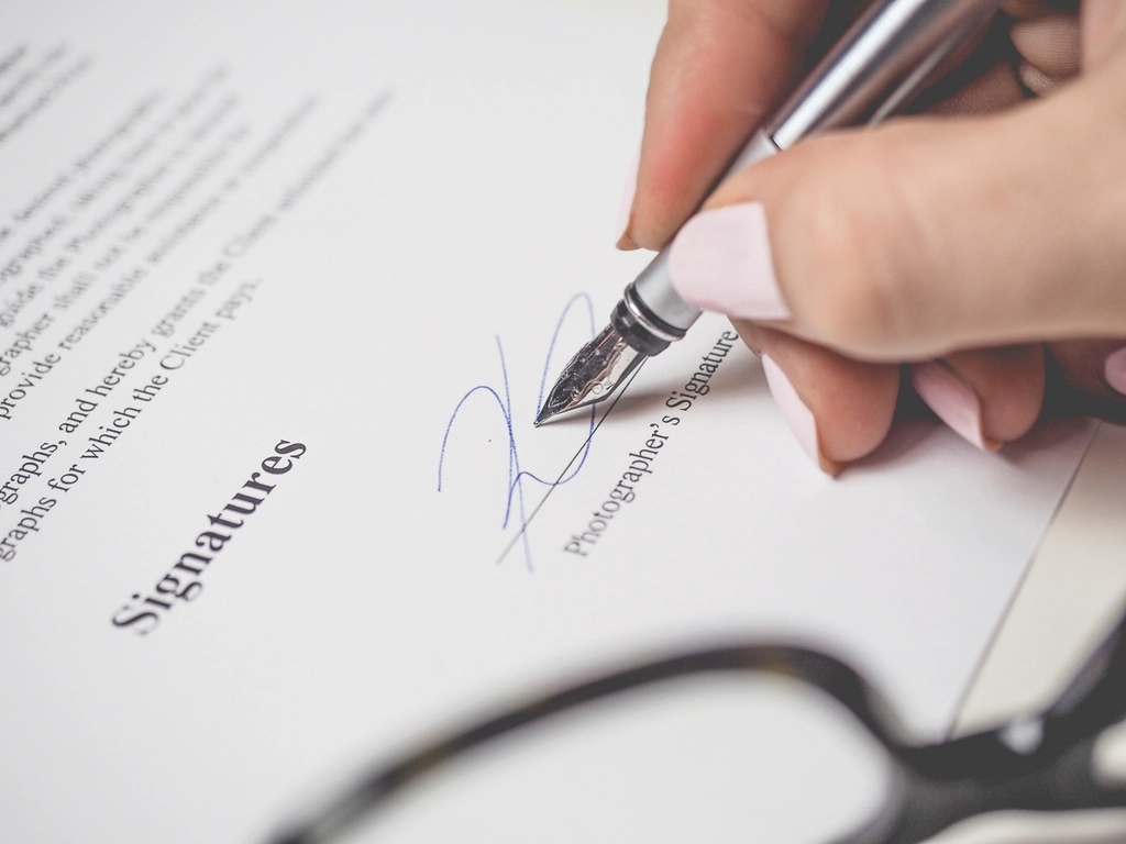 Signing a business acquisition contract with a pen